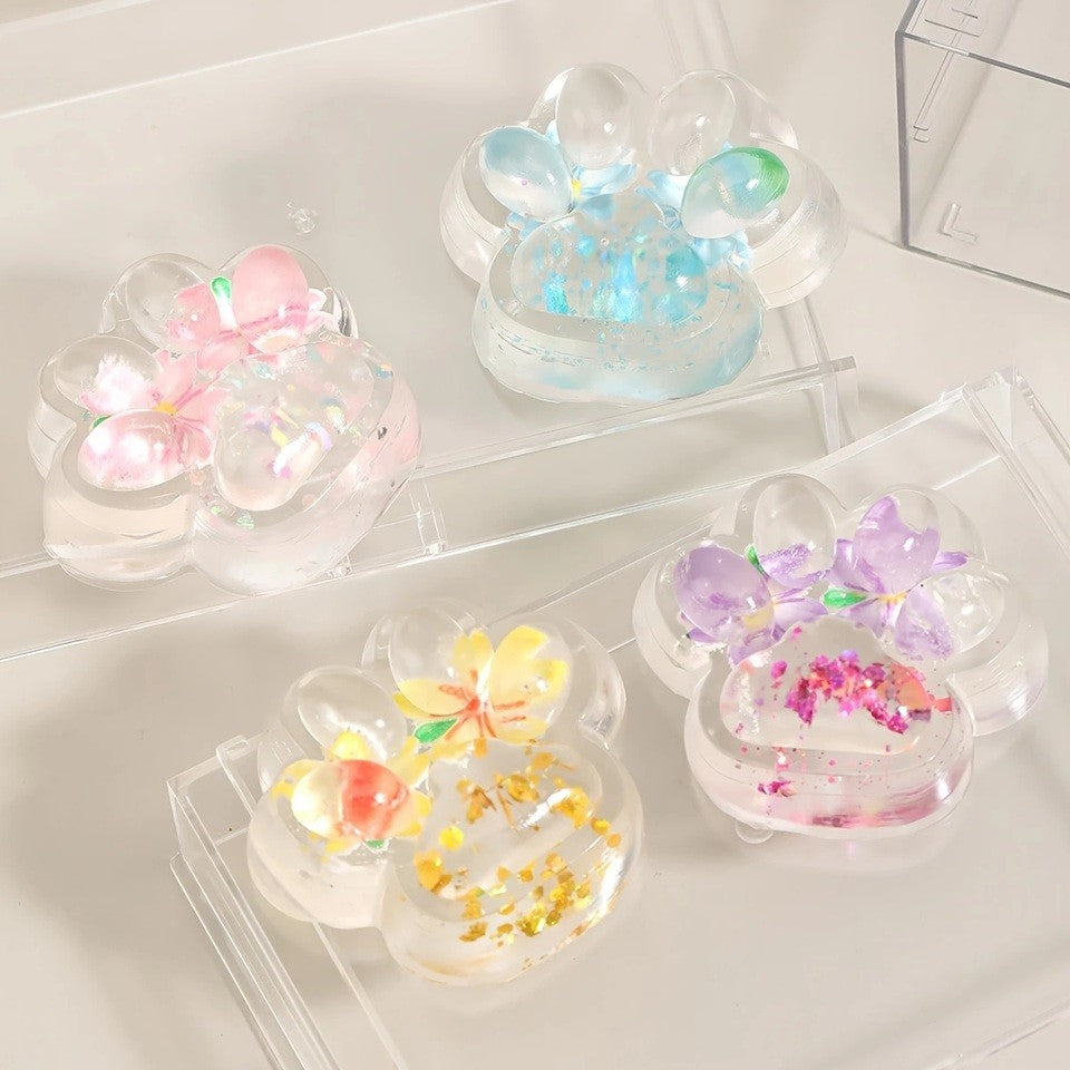 Jucarie Antistres Squishy Labuta de Pisica, Revenire Lenta pentru Relaxare si Senzorial, Material TPR Moale, Model Flori, 7 x 6.5 cm, Transparent Multicolor