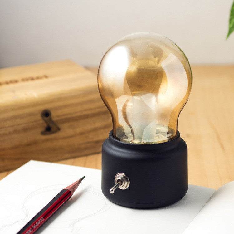 Lampa LED Decorativa Retro sub Forma de Bulb, Lumina Calda, Incarcare USB, Autonomie 12 Ore, Comutator Metalic, ABS si Sticla, Negru Transparent, 11x7x6 cm