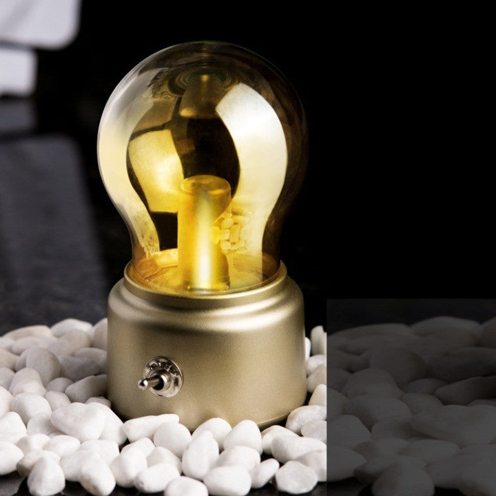 Lampa LED Decorativa Retro Sub Forma De Bulb, Lumina Calda, Comutator Metalic, Incarcare USB, Autonomie 12 Ore, Sticla si ABS, Bej Transparent, 11x7x6 cm