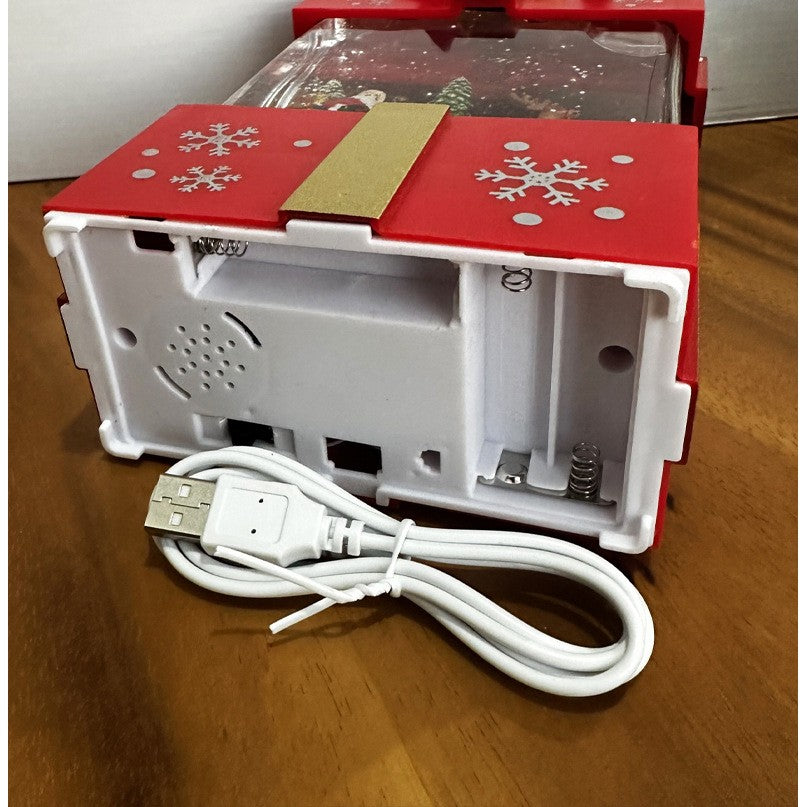 Decoratiune Craciun Muzicala Tip Cutie Cadou, Mos Craciun cu Sania si Zapada in Miscare, Lumini LED Alb Cald, 3 Moduri Functionare, Alimentare USB sau Baterii, Plastic, Rosu si Auriu, 13 x 9 x 19.8 cm